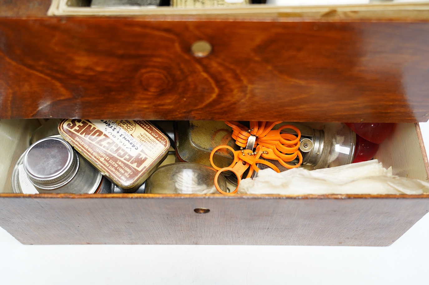 A collection of watch parts, tools and a small selection of costume jewellery, housed in two cases, together with two books. Condition - poor to fair